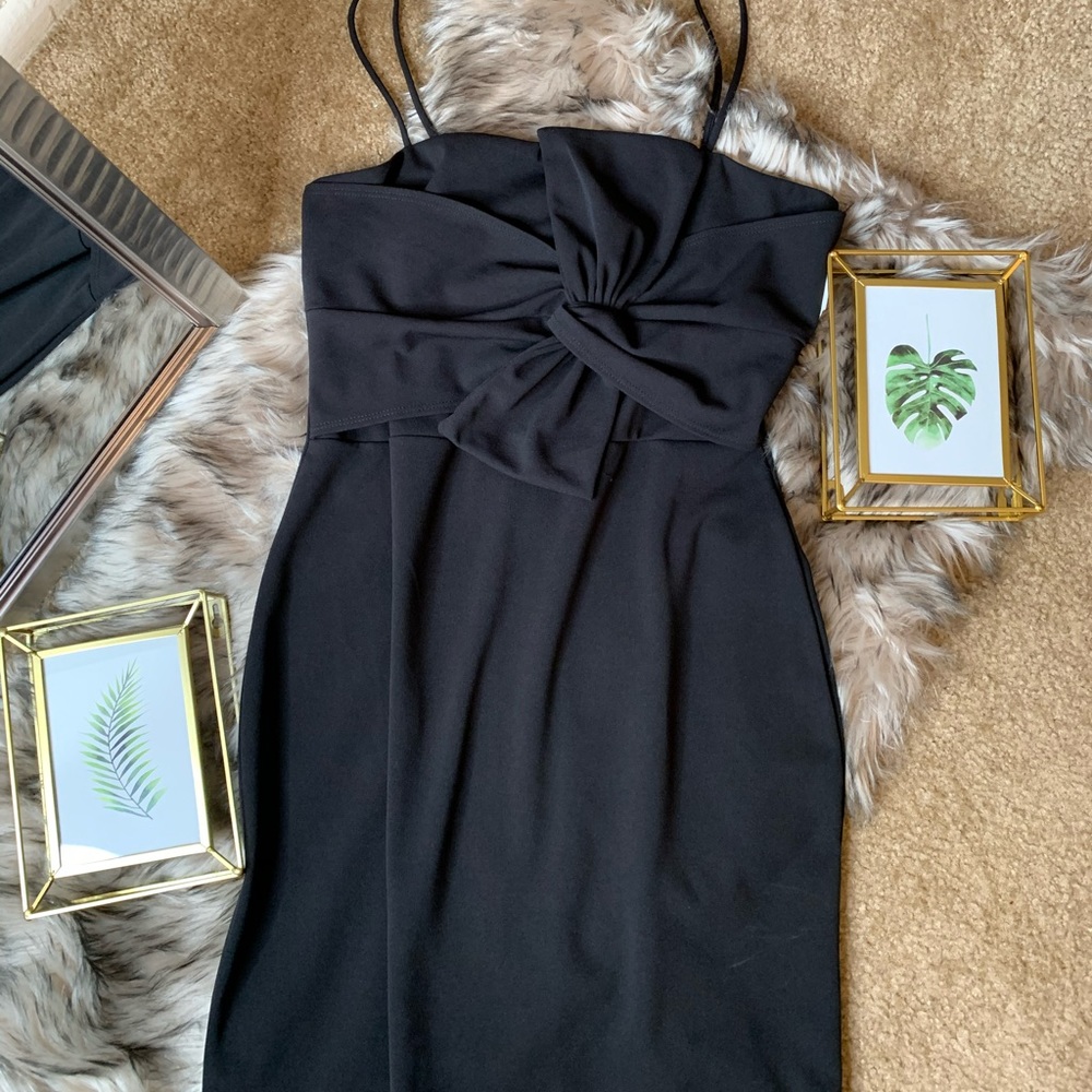 Black short cocktail dress with bow in the center.